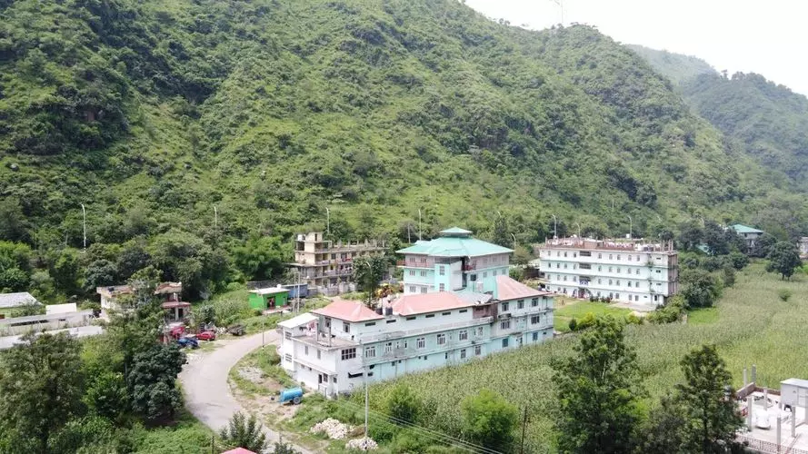 green color college campus building in mountains
