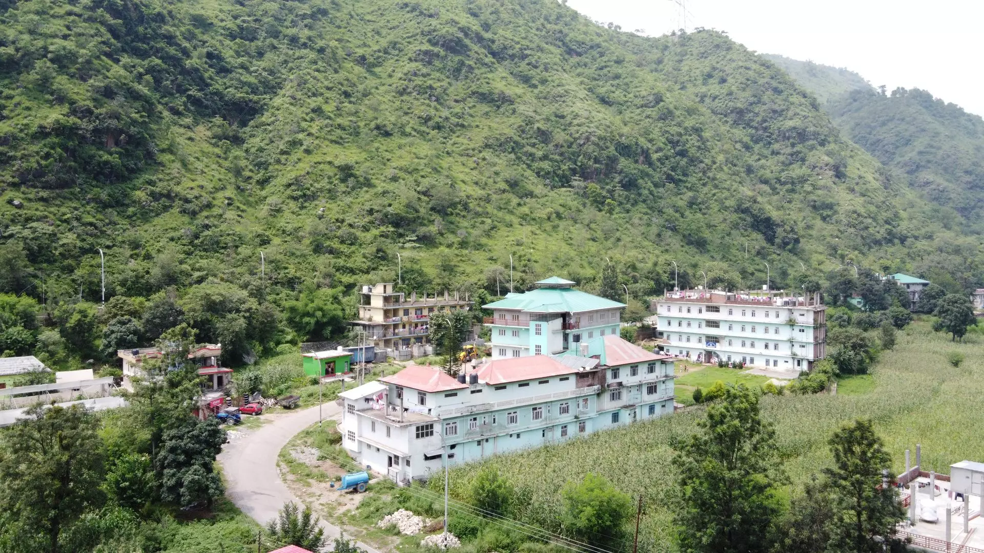 green color college campus building in mountains