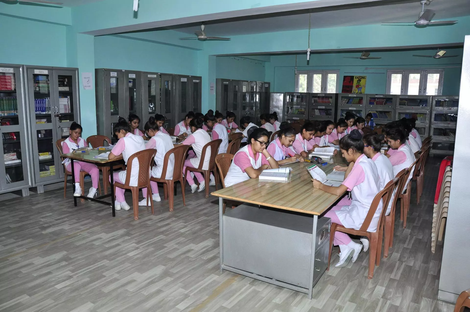 girls students studing in the library in uniform