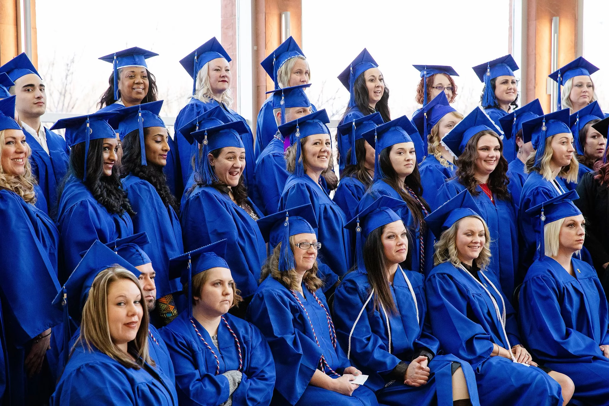 girls stand in a group within bluedress
